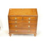 A C19th walnut fall front bureau with fitted interior and two over three drawers with pressed