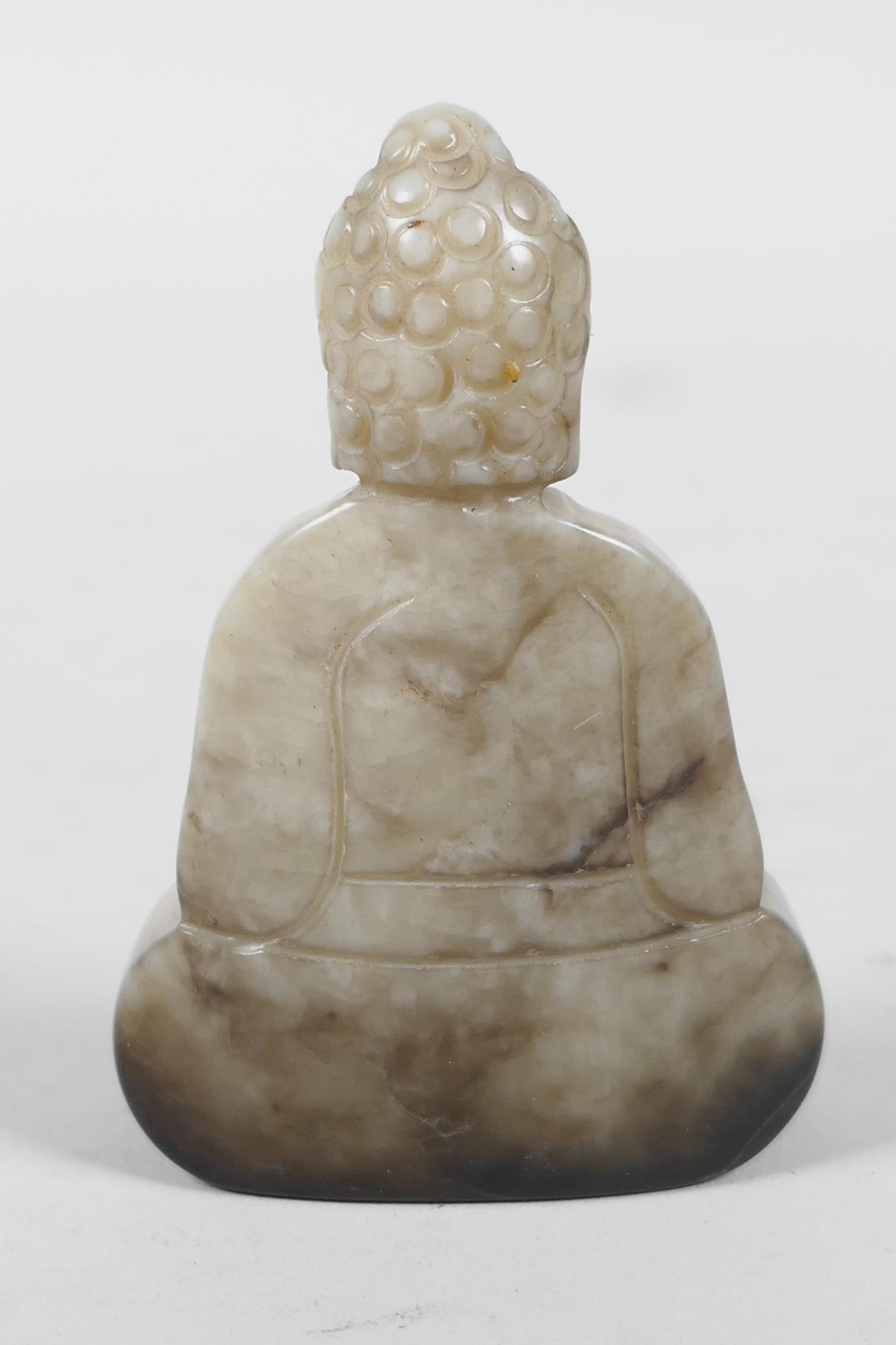 A Chinese mottled hardstone carving of Buddha, 2½" high - Image 2 of 2