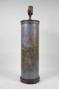 A pewter and brass cylinder lamp with Chinese decoration depicting figures and a buffalo, 21" high