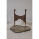An antique wrought iron bootscraper mounted on a stone base, 16" x 10" x 15"