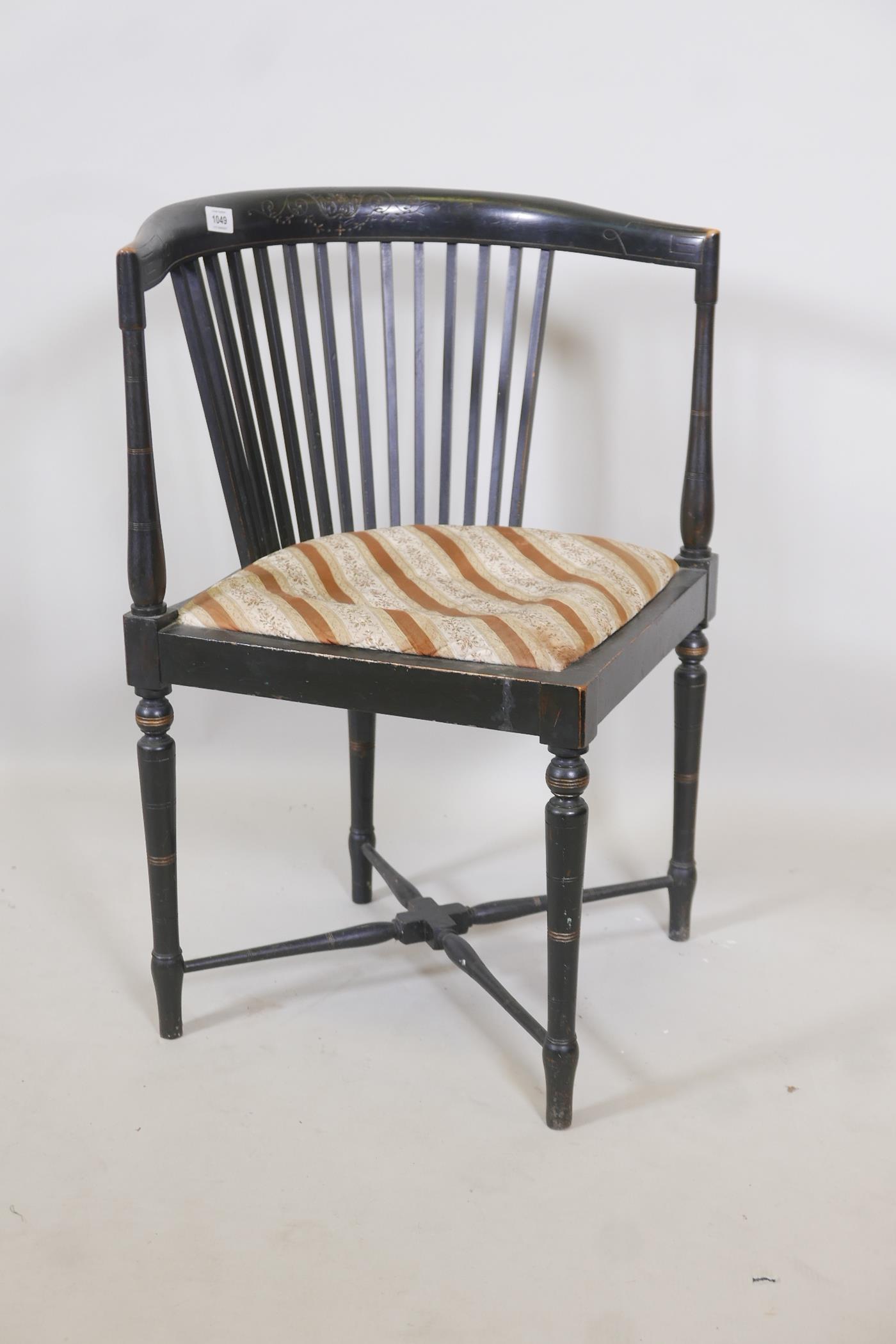 A C19th Aesthetic style ebonised corner chair with slat back, raised on ring turned tapering
