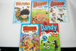 Four children's annuals, The Dandy 1984, The Beano 1984-85 and 1997, and The Beezer 1992