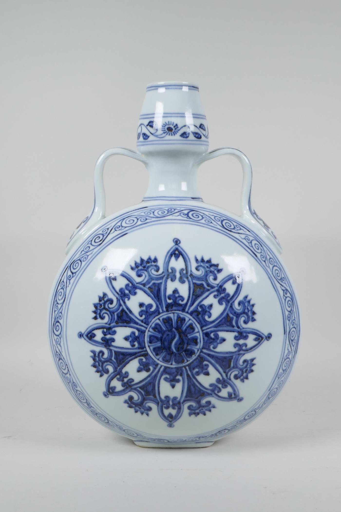 A Chinese Ming style blue and white garlic head shaped flask with two handles and Yin Yang