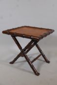 A hardwood occasional table carved in the form of bamboo, with a leather top, 20" x 20", 20" high