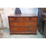 A mahogany chest of three over two long drawers, with crossbanded top, raised on a shaped plinth,