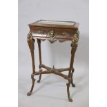 A C19th oak bijouterie table with Renaissance revival style brass mounts, and glazed lift up top,