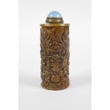 A Chinese soapstone snuff bottle with carved dragon decoration, 3" high