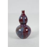 A Chinese red and blue flambe glazed porcelain double gourd vase, 7½" high