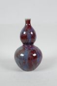 A Chinese red and blue flambe glazed porcelain double gourd vase, 7½" high