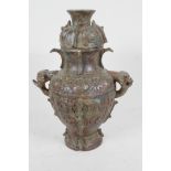 An archaic bronze jar and cover, the bulbous body with two mythical animal head handles and all over