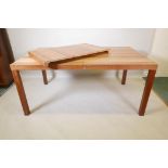 A Danish Dyrlund mid century teak and exotic wood extending dining table with a extra leaf and