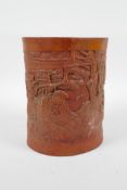 A Chinese carved bamboo brush pot decorated with a sage in a landscape, 6½" high