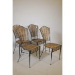 A set of four wrought metal conservatory chairs, with bamboo seats and backs