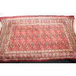 A small Bokhara pattern red ground rug, 44" x 26"