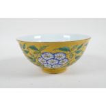 A Chinese polychrome porcelain rice bowl with enamelled floral decoration on a yellow ground, 4