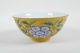 A Chinese polychrome porcelain rice bowl with enamelled floral decoration on a yellow ground, 4
