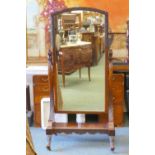 A C19th walnut cheval mirror with carved frame