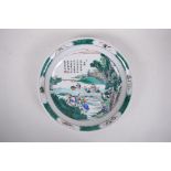 A Chinese famille verte porcelain charger decorated with a rural landscape depicting rice paddy