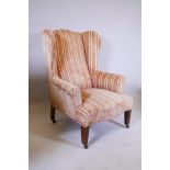 A late C18th/early C19th mahogany framed wing armchair on tapered and reeded front supports and