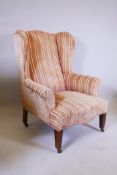 A late C18th/early C19th mahogany framed wing armchair on tapered and reeded front supports and