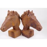 A pair of cast iron horse's head garden ornaments, 12" high
