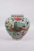 A Chinese wucai porcelain jar with phoenix decoration, 8½" high