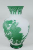 A Peking glass vase with cut green overlay over white, depicting butterflies and flowering branches,