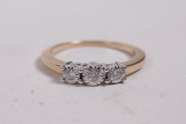 A 9ct gold ring set with three diamonds, 0.7ct, size O