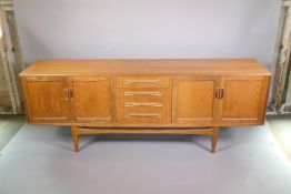A mid C20th G-Plan 'Fresco' teak sideboard with a flight of four drawers flanked by cupboards,