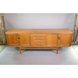 A mid C20th G-Plan 'Fresco' teak sideboard with a flight of four drawers flanked by cupboards,