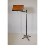 A Victorian adjustable music stand, with brass column and cast iron base, 48" high