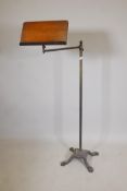 A Victorian adjustable music stand, with brass column and cast iron base, 48" high