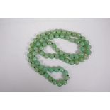 A Chinese jade bead necklace, 33" long