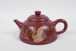 A Chinese Yixing teapot with crane decoration and inscription verso, impressed seal mark to base, 4"