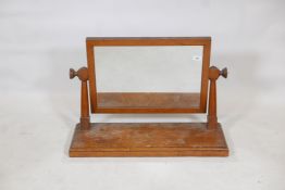 An Arts and Crafts oak swing toilet mirror, 10" x 30" x 20"