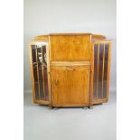 An Art Deco walnut side cabinet with fall front secretaire, over a pull out and removable cocktail