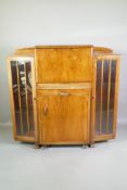 An Art Deco walnut side cabinet with fall front secretaire, over a pull out and removable cocktail