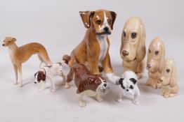 A collection of dog figurines, including three Sylvac sad spaniels, an Italian Boxer puppy, 8" high,