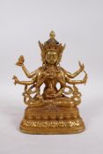 A Tibetan gilt bronze of a many armed deity, double vajra mark to base, 9" high