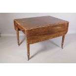 A Georgian mahogany drop leaf table with rosewood banded top and single end drawer, raised on ring