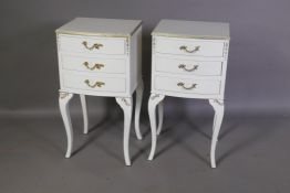 A pair of bow fronted painted bedside chests with three drawers, raised on shaped supports, 14" x