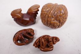 Three carved wooden netsuke and a walnut shell carved with many faces (4)