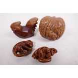 Three carved wooden netsuke and a walnut shell carved with many faces (4)