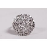 An unmarked white gold and diamond cluster dress ring, probably 18ct, approximate size 'S'