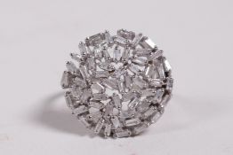 An unmarked white gold and diamond cluster dress ring, probably 18ct, approximate size 'S'