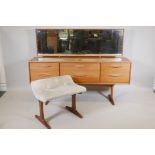 A 1970s teak low dressing table and stool, the six drawers with curled handles, 61" x 16½", 45" high