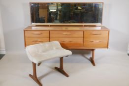 A 1970s teak low dressing table and stool, the six drawers with curled handles, 61" x 16½", 45" high