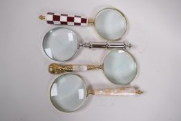 Four various desk top magnifying glasses, lenses 4" diameter