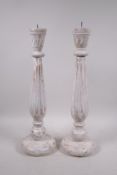 A pair of painted, turned wood pricket candlesticks with a distressed finish, 18" high