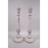 A pair of painted, turned wood pricket candlesticks with a distressed finish, 18" high